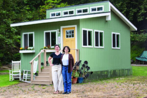 nova cottage founders in front of cottage
